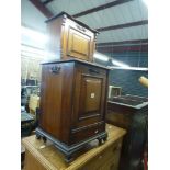 A Victorian walnut coal podium with cupboard superstructure on bracket feet. FOR DETAILS OF ONLINE