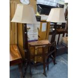 A pair of mahogany standard lamps, each with fruited and turned columns on tripod supports, and