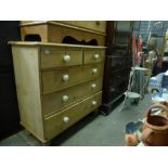 A Victorian polished pine chest of two short over three long drawers with white porcelain handles.