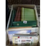 A carton containing a quantity of First Day Covers, Royal Mail postcards, mint stamps, including a