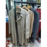 A gents' Burberrys raincoat, a Lanvin raincoat and a grey Burberrys overcoat [rail in hall] FOR