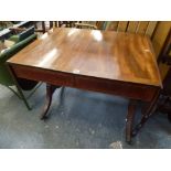 A Regency mahogany sofa table cross-banded in rosewood above a pair of frieze drawers on sabre