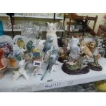 A collection of bird figurines such as kingfishers, owls and budgies including Leonardo