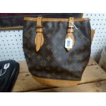 A Louis Vuitton ladies handbag of bucket design in monogram print with tan leather strap and trim [