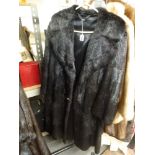 A lady's full length dark brown/black mink fur coat with hook fastening and two decorative sham