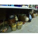 A quantity of copperwares including frying pans, pots, trivet, three stoneware pots, a ceramic