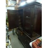 A 19th century mahogany linen press the pair of panel doors above two short and three long drawers