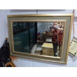 A pretty modern gilt-framed rectangular mirror with bevel glass. FOR DETAILS OF ONLINE BIDDING ON
