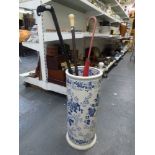 A blue and white stick stand plus a Victorian folding parasol, ebony walking cane and others [next