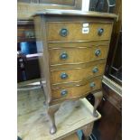 A reproduction miniature serpentine walnut chest of four drawers on cabriole legs. FOR DETAILS OF