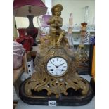 A 19th century spelter clock decorated with a seated piper on wooden base [s17] FOR DETAILS OF
