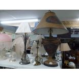 Three table lamps comprising a classical style table lamp with matching shade, another in brass