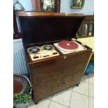 A 1950s radiogram by Collaro with cream Perspex deck incorporating a Collaro reel-to-reel tape