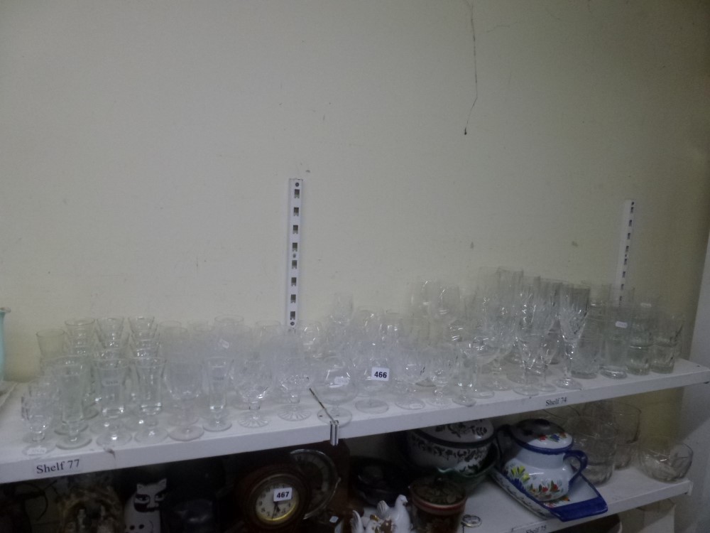 A shelf and glass of mainly drinking glasses including a set of six cut glass champagne flutes,