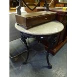 A cast iron Victorian-style pub table with ornate base supporting a circular marble top. FOR DETAILS