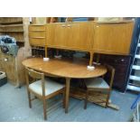A 1970s teak dining room suite by Mackintosh comprising an extending oval dining table, four
