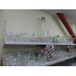 Three shelves of glassware including Dartington glass vases, shot glasses, brandy balloons,