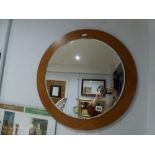 A stylish circular teak wall mirror. FOR DETAILS OF ONLINE BIDDING ON THIS LOT CONTACT BAINBRIDGES
