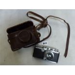 A Leica camera, no. 194131, with Summar lens f 5cm 1:2 no. 287059, the case in grainy black and in