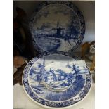 Two large blue and white circular Delft chargers, four small similar Delft plates and two tiles [