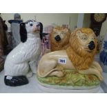 A pair of large Staffordshire pottery figures of recumbent lions, circa 1900, 10.6 in long, and a