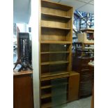 A pair of Phoenix bookcases each behind sliding glass doors with two adjustable shelves, a third