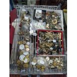 Five cartons of watch movements, costume jewellery and military buttons. FOR DETAILS OF ONLINE