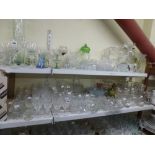 A quantity of glass including red and white wine glasses, fruit bowls, decanters and stoppers, green