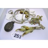 A Victorian grouse claw brooch mounted in silver, and two silver bracelets, two chains, a locket and