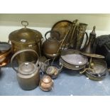 A collection of brass ware including fireside implements, a pail and cover, kettles, trays, trivets,