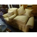 A substantial and very comfortable settee upholstered in a modern cream patterned fabric with