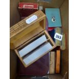 A small carton containing a quantity of vintage playing cards and card boxes some dating to the