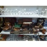 A shelf of wooden wares including a carved pricket candle stand, brass-bound boxes, fruit bowls