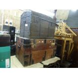 Two old wooden cabin trunks each with metal bindings one with a domed top. FOR DETAILS OF ONLINE