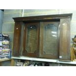 A charming Victorian oak cabinet of two glazed doors flanked by cupboards with inlaid decoration. [