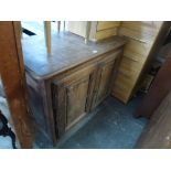An 18th century French cupboard, possibly in chestnut, enclosed by a pair of panelled doors. FOR