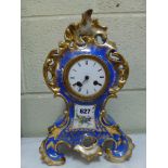 A 19th century French porcelain mantel clock in rococo style, gilt on a blue ground, silk suspension