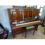 An upright piano by Bechstein retailed by Harrods the frame numbered 75697 in a figured case. FOR
