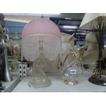 A glass and silver-plated claret jug and a glass figural Lalique-style table lamp with pink glass