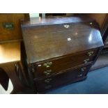 A Georgian oak bureau, the fall above four graduated long drawers on bracket feet. FOR DETAILS OF