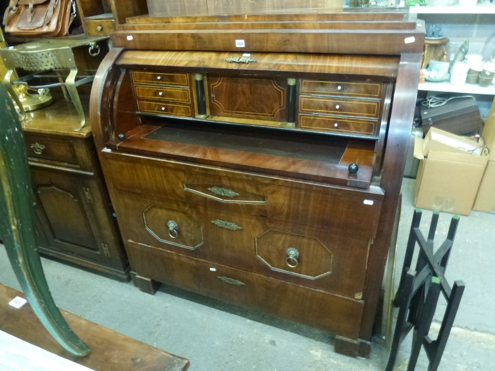 A fine 19th century continental barrel-fronted bureau in figured mahogany revealing a fitted