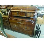 A fine 19th century continental barrel-fronted bureau in figured mahogany revealing a fitted