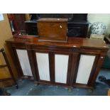 A fine Regency breakfront sideboard with brass inlay, enclosed by four fabric panelled doors on