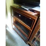 A Globe Wernicke three-section glazed bookcase in mahogany. FOR DETAILS OF ONLINE BIDDING ON THIS