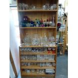 A large collection of glassware including glasses, fruit bowls and vases [shelves near back door]