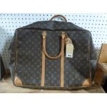 A Louis Vuitton holdall in brown monogram print with tan leather trim [upstairs wooden shelves]