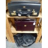 A black leather Masters briefcase with combination lock, a burgundy leather Flaurose briefcase and