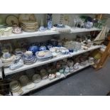 Two shelves of mixed china items including blue and white ginger jars and covers, further blue and