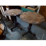 A pair of Flemish oak occasional tables, each with a leaf-styled circular top on a carved