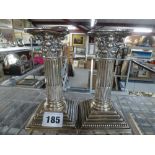 A pair of filled silver Corinthian columnar candlesticks, complete with nozzles, 6 in high,